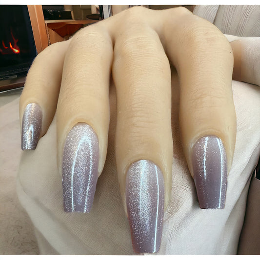 Hand with long coffin shape press-on nails in silver Ombre color