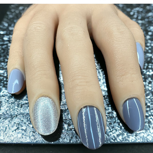 Hand with fingers adorned in sparkly grey monochrome short round press-on nails