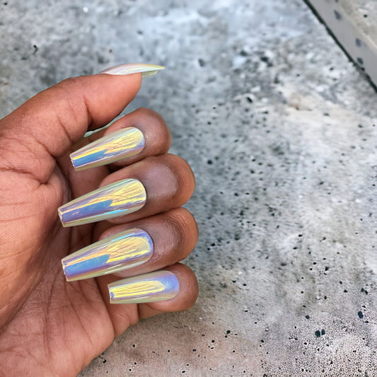 Hand featuring long coffin-shaped blue chrome press-on nails on a neutral background