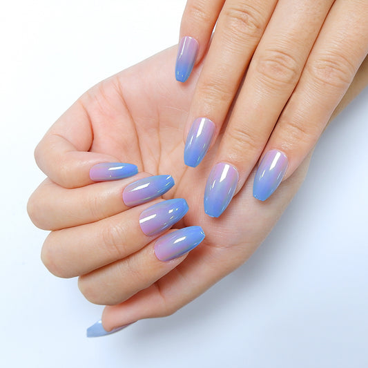 Fingers adorned with almond-shaped press-on nails in pink and blue chrome hues, against a white background.